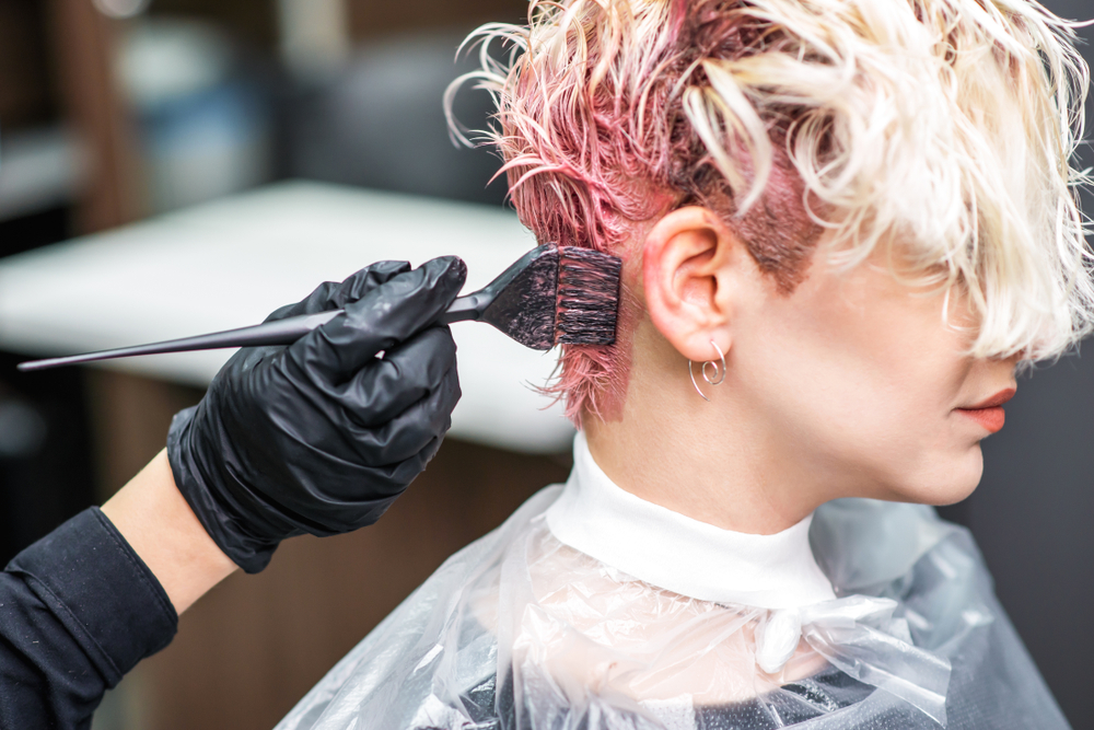 The,Professional,Hairdresser,Uses,A,Brush,To,Apply,The,Pink